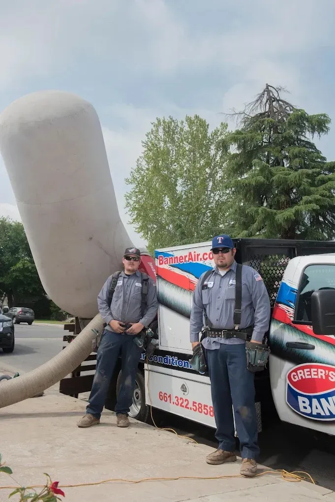 Technician cleaning ductwork to improve HVAC efficiency and air quality